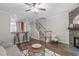 Open-concept living room featuring wood floors, a fireplace, and barstool seating at 4535 Sugarbend Way, Raleigh, NC 27606