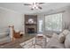 Inviting living room with a fireplace, wood floors, and comfortable seating area at 4535 Sugarbend Way, Raleigh, NC 27606