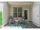 Covered patio featuring two chairs and a small table with a decorative rug and a view of backyard at 4535 Sugarbend Way, Raleigh, NC 27606