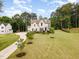 Expansive aerial view shows a well-manicured lawn, circular driveway, and a beautiful single-Gathering home at 46 Bonterra Way, Chapel Hill, NC 27516