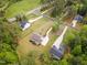 Aerial view of the home set on a large lot surrounded by mature trees and well-maintained landscaping at 46 Bonterra Way, Chapel Hill, NC 27516