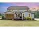 Expansive backyard featuring a screened porch, wooden deck, and lush landscaping, offering ideal outdoor living at 46 Bonterra Way, Chapel Hill, NC 27516