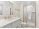 Bright bathroom features a glass shower enclosure and white vanity with gold hardware at 46 Bonterra Way, Chapel Hill, NC 27516