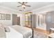 Bright bedroom showcasing gray walls, a ceiling fan, a mirrored dresser and ensuite bathroom access at 46 Bonterra Way, Chapel Hill, NC 27516