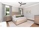 Well-lit bedroom with neutral tones, hardwood floors and a modern ceiling fan at 46 Bonterra Way, Chapel Hill, NC 27516