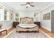 Spacious bedroom featuring a luxurious bed, hardwood floors, and abundant natural light from the windows at 46 Bonterra Way, Chapel Hill, NC 27516