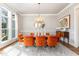 Elegant dining room featuring modern chandelier, seating for eight, and bright natural light at 46 Bonterra Way, Chapel Hill, NC 27516