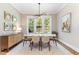 Bright dining room featuring a modern chandelier, outdoor views, and seating for six at 46 Bonterra Way, Chapel Hill, NC 27516