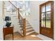 Bright foyer featuring hardwood floors, staircase, and natural light from large windows at 46 Bonterra Way, Chapel Hill, NC 27516