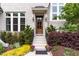 Charming front entrance with wood door, black accents, and vibrant landscaping at 46 Bonterra Way, Chapel Hill, NC 27516