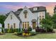 Charming home featuring a painted brick facade, dormer windows, and a professionally landscaped front yard at 46 Bonterra Way, Chapel Hill, NC 27516
