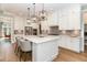 Spacious kitchen with white cabinets, large island, and pendant lighting at 46 Bonterra Way, Chapel Hill, NC 27516