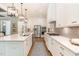 Bright kitchen featuring white cabinets, stainless steel appliances, and modern fixtures at 46 Bonterra Way, Chapel Hill, NC 27516