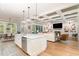 Open concept kitchen and living room with white cabinets and coffered ceilings at 46 Bonterra Way, Chapel Hill, NC 27516