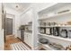 Walk-in pantry with custom shelving, cabinets, and modern appliances at 46 Bonterra Way, Chapel Hill, NC 27516