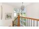 Bright staircase with large windows, wooden railings, and modern chandelier at 46 Bonterra Way, Chapel Hill, NC 27516