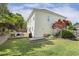 Wide shot of backyard with a deck, seating, a landscaped garden, a grassy lawn, and a two-story home at 5213 Holly Ridge Farm Rd, Raleigh, NC 27616