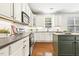 Open kitchen with white cabinets, an island, stainless appliances, and sleek countertops at 5213 Holly Ridge Farm Rd, Raleigh, NC 27616