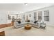 Spacious living room with an L-shaped couch and ample natural light flowing in from large windows at 5213 Holly Ridge Farm Rd, Raleigh, NC 27616