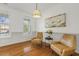 Cozy sitting room with two leather chairs, hardwood floors, and decorative wainscoting at 5213 Holly Ridge Farm Rd, Raleigh, NC 27616