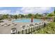 Community pool with lounge chairs and umbrellas surrounded by green landscaping at 5213 Holly Ridge Farm Rd, Raleigh, NC 27616