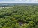 Aerial view of the home nestled among the trees on a beautiful wooded lot with complete privacy at 5402 Shealtiel Way, Rougemont, NC 27572