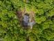 Aerial view of a home surrounded by lush greenery, showcasing its private and serene setting at 5402 Shealtiel Way, Rougemont, NC 27572