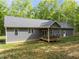 The backyard features a cozy, partially covered deck perfect for relaxing outdoors at 5402 Shealtiel Way, Rougemont, NC 27572