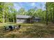 Spacious backyard featuring a wooden deck, and a cozy fire pit area, perfect for outdoor gatherings at 5402 Shealtiel Way, Rougemont, NC 27572