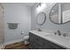 Bathroom featuring double sinks with granite countertops, dual mirrors, and modern fixtures at 5402 Shealtiel Way, Rougemont, NC 27572