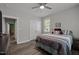 Bedroom featuring a double-door closet for ample storage space and a ceiling fan for climate control at 5402 Shealtiel Way, Rougemont, NC 27572