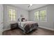 Cozy bedroom with wood floors, filled with natural light from the windows, creating a warm and inviting space at 5402 Shealtiel Way, Rougemont, NC 27572