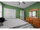 Bedroom featuring a dresser with a mirror and a double-door closet, offering plenty of storage options at 5402 Shealtiel Way, Rougemont, NC 27572