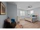 Serene bedroom with hardwood floors, a ceiling fan, and large windows providing natural light at 5402 Shealtiel Way, Rougemont, NC 27572