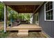 Inviting covered deck with comfortable seating and a ceiling fan, perfect for outdoor relaxation at 5402 Shealtiel Way, Rougemont, NC 27572