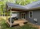 Cozy wooden deck with comfortable seating, offering a relaxing outdoor space at 5402 Shealtiel Way, Rougemont, NC 27572