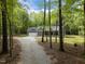 Beautiful home with a long gravel driveway winding through a wooded landscape, providing privacy at 5402 Shealtiel Way, Rougemont, NC 27572