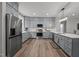 Kitchen boasts stainless steel appliances, stylish gray cabinets, and a spacious layout at 5402 Shealtiel Way, Rougemont, NC 27572