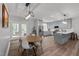 Open kitchen and dining area with stainless appliances, grey cabinets, and backyard access at 5402 Shealtiel Way, Rougemont, NC 27572