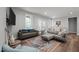 Comfortable living room features hardwood floors, a large sectional, and ample natural light at 5402 Shealtiel Way, Rougemont, NC 27572