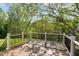 Outdoor deck surrounded by lush greenery, perfect for relaxation and outdoor enjoyment at 5504 Creekdale Cir, Raleigh, NC 27612