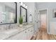 Bathroom with dual sinks, granite countertops, and modern fixtures at 5504 Creekdale Cir, Raleigh, NC 27612