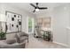 Cozy bedroom with neutral tones, a ceiling fan, and a comfortable sitting area at 5504 Creekdale Cir, Raleigh, NC 27612