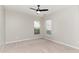 Neutral bedroom featuring plush carpet, a ceiling fan, and double windows at 5504 Creekdale Cir, Raleigh, NC 27612