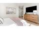 Comfortable bedroom featuring hardwood floors and a dresser at 5504 Creekdale Cir, Raleigh, NC 27612
