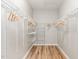 Walk-in closet with wooden floors and metal shelving provides ample storage space at 5504 Creekdale Cir, Raleigh, NC 27612