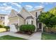 Charming home featuring neutral siding, bay window, manicured landscaping, and an attached garage at 5504 Creekdale Cir, Raleigh, NC 27612