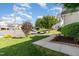 Well-maintained front yard with lush green grass, mature trees, and a sidewalk at 5504 Creekdale Cir, Raleigh, NC 27612