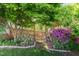 Charming garden gate surrounded by colorful blooming bushes and lush greenery at 5504 Creekdale Cir, Raleigh, NC 27612