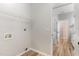 Bright laundry room with tile flooring, wire shelving, and utility connections at 5504 Creekdale Cir, Raleigh, NC 27612